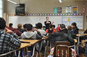 Analaura Garcia of Wells Fargo with Eliot Arts magnet sixth graders. Analaura Garcia of Wells Fargo at Eliot Arts magnet
