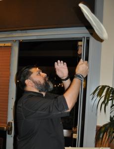 Alex Montes demonstrates proper pizza throwing at our February Mixer at California Pizza Kitchen CPK pizza toss