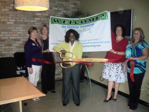 Myisha Blackman cut a ribbbon to open In Good Hands Interpreting.
