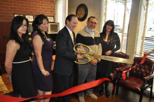 R. Ross Jacinto cut the ribbon to open his new law office.