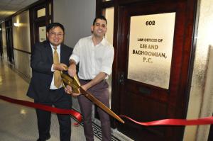 Joseph Lee and Steve Baghoomian cut the ribbon to celebrate the opening of their law firm in Pasadena.